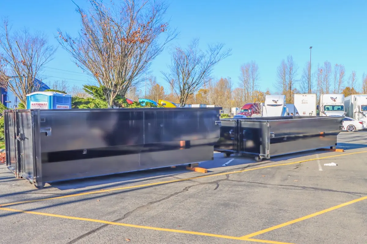 Professional dumpster rental service with roll-off container on residential driveway in Crete